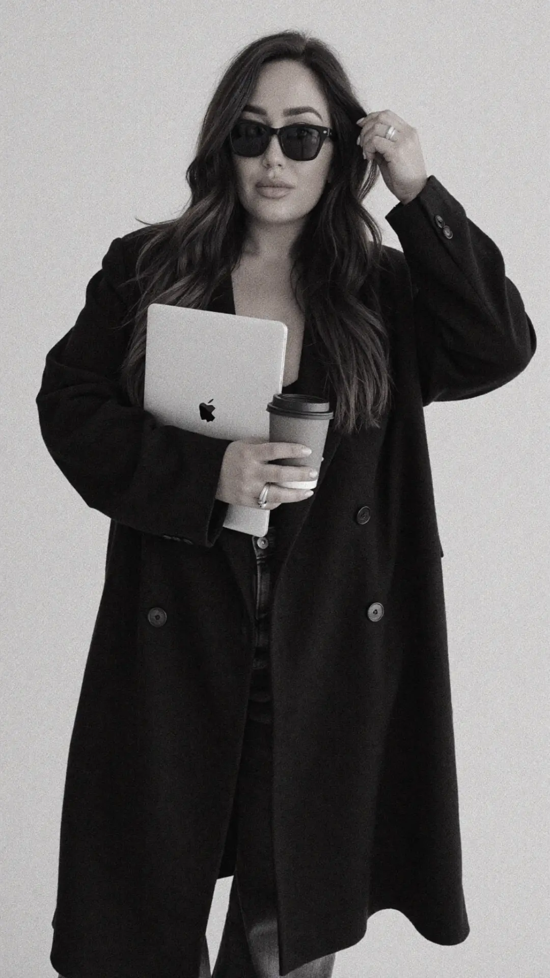 AI systems builder holding a laptop and coffee